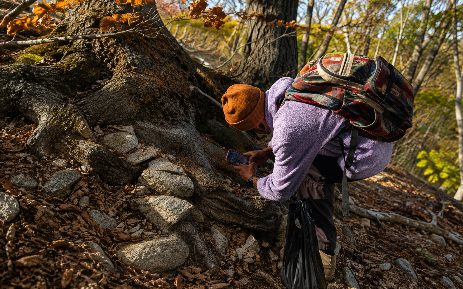 Photo of me on a hike taking photos of moss on a tree