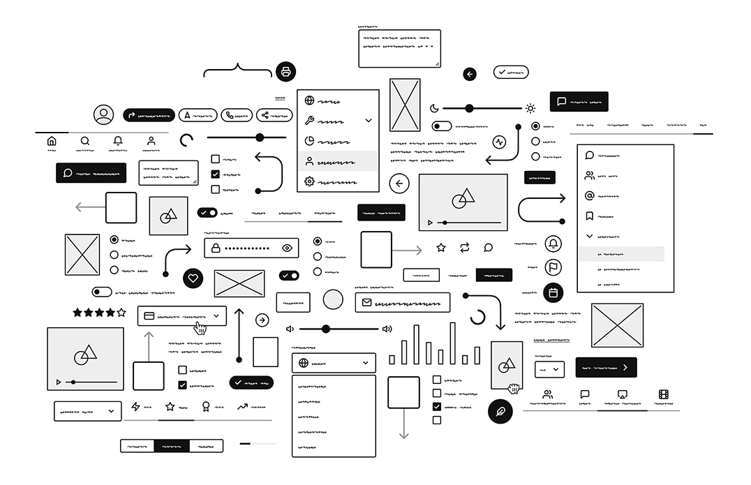 Wireframe sketches and layout grid for a modern website pinned on a desk